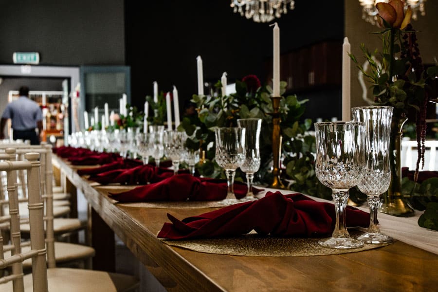 Formal dining setup with burgundy accents