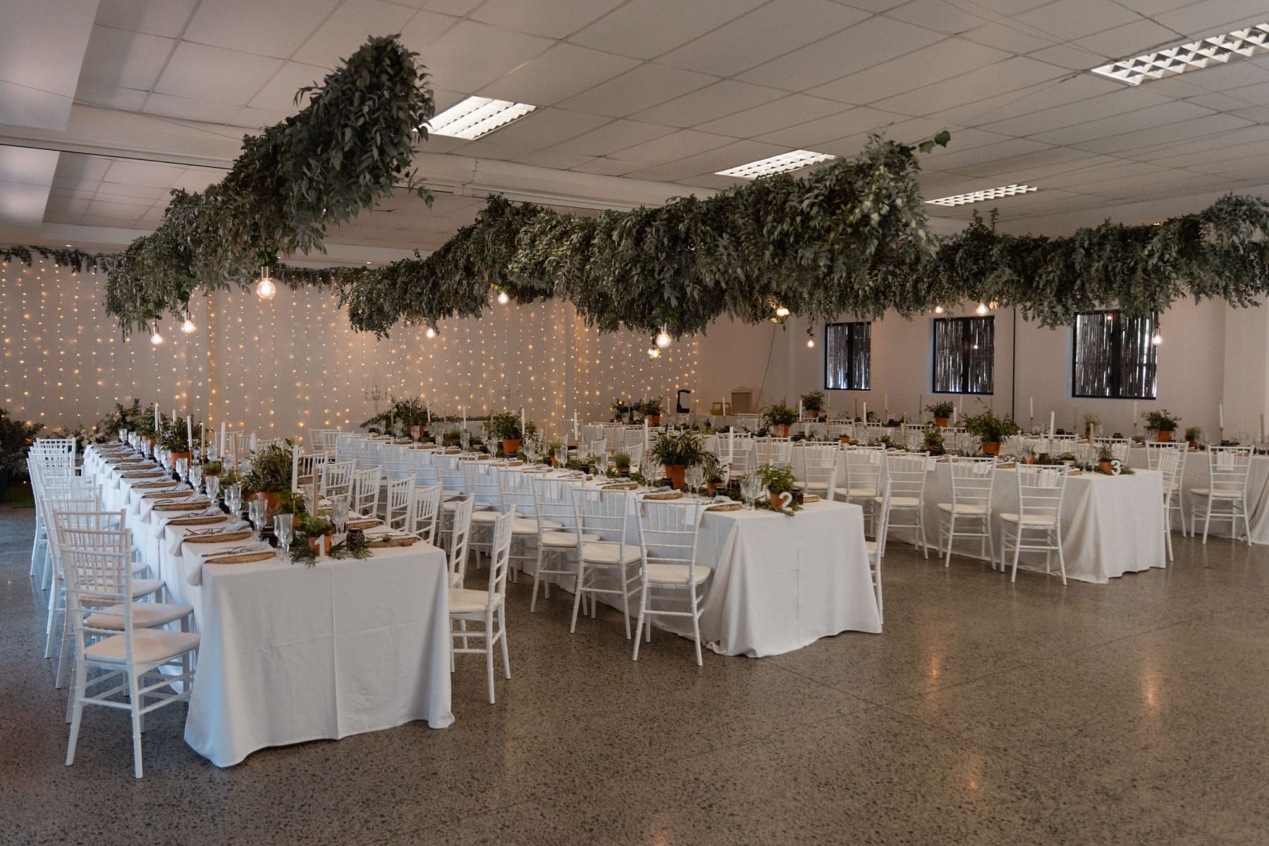 Full venue setup with hanging greenery